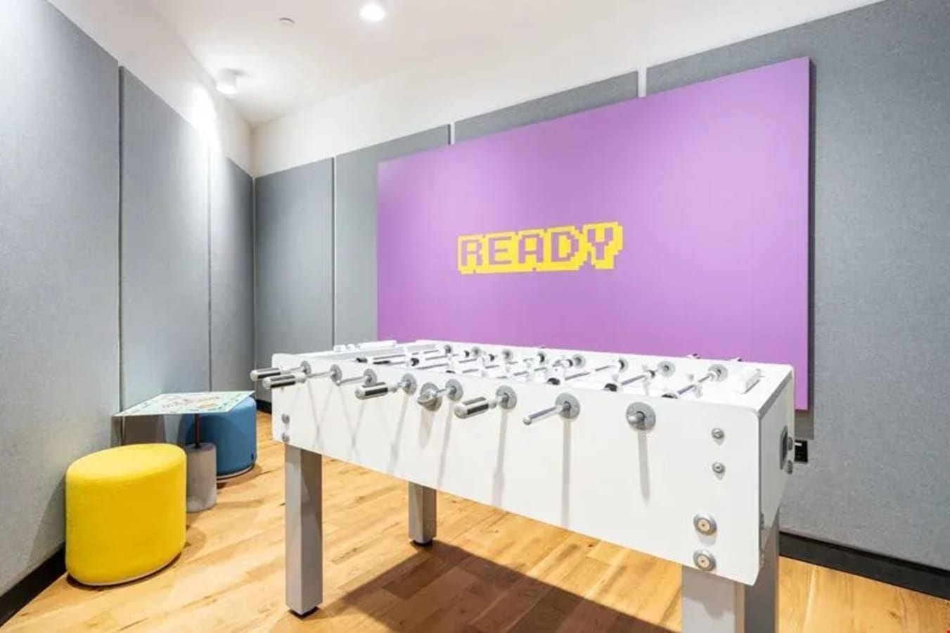 Vibrant game room with foosball table and colorful decor in a flexible coworking space on Robinson Road.