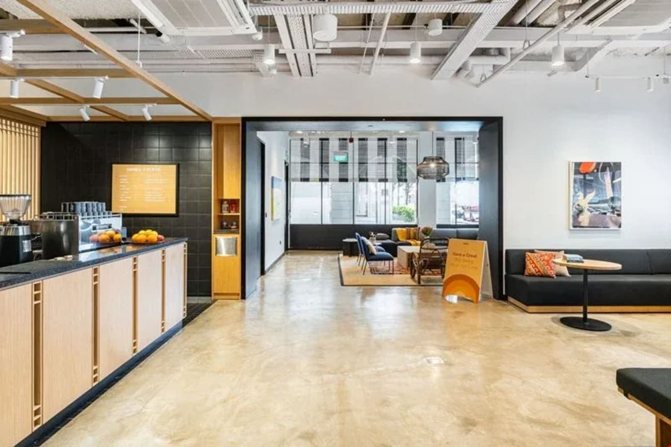Modern coworking space with sleek seating, natural light, and inviting collaborative areas.