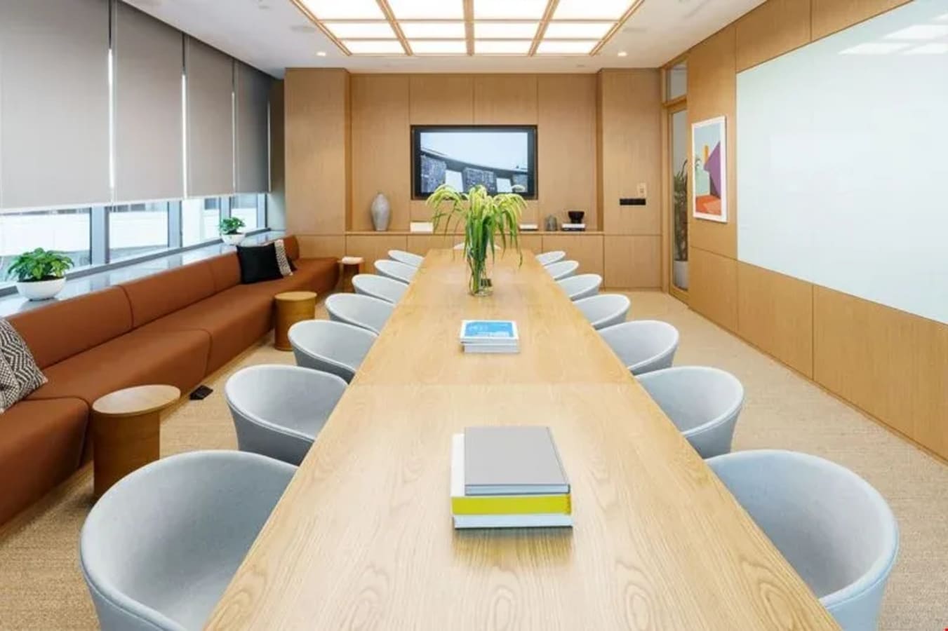 Sleek meeting room with ample seating, natural light, and modern finishes. Ideal for collaboration.