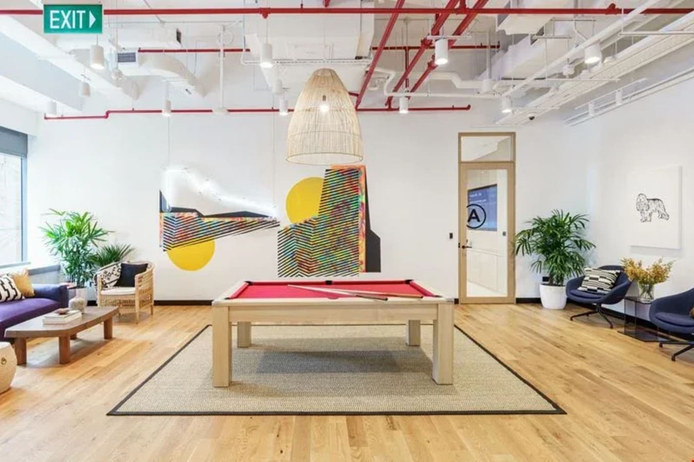 Bright coworking lounge with a pool table, modern decor, and comfortable seating in Battery Road.