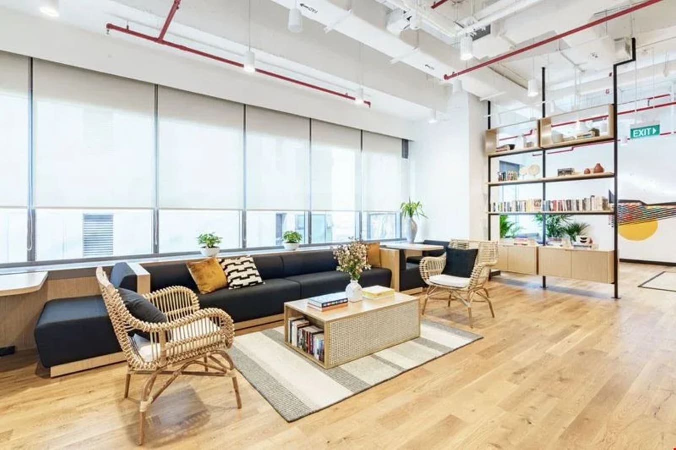 Bright, open coworking space with modern decor, natural light, and cozy seating on Battery Road.
