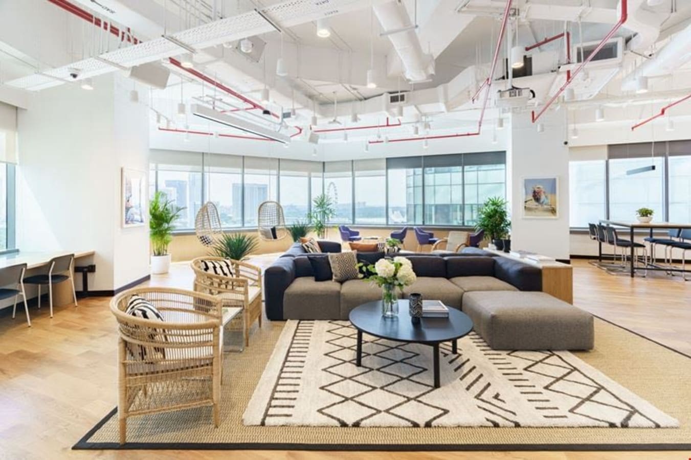 Stylish coworking space with modern decor, ample seating, and stunning city views.