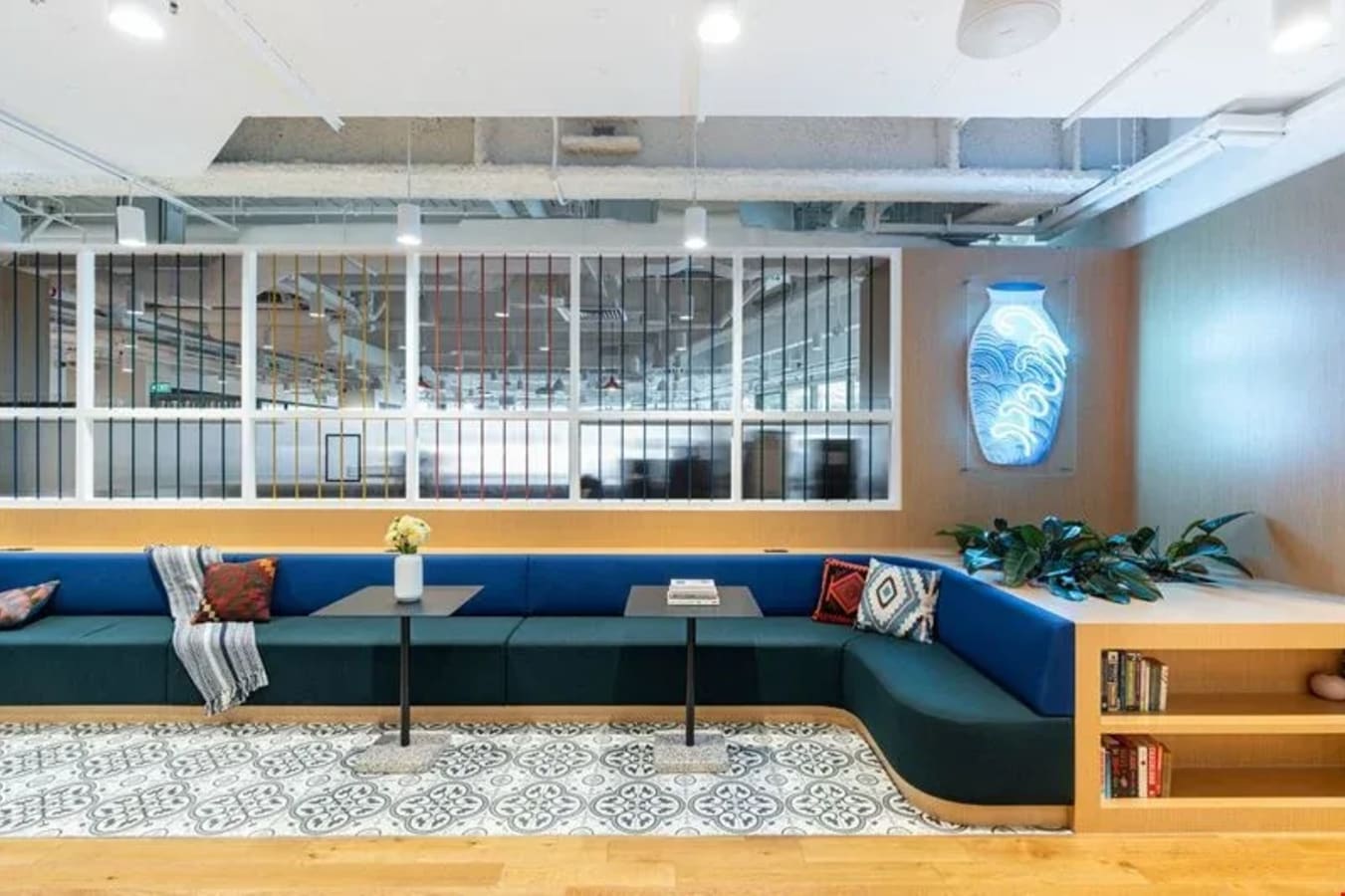 Bright, modern coworking lounge with cozy seating, vibrant decor, and ample natural light.