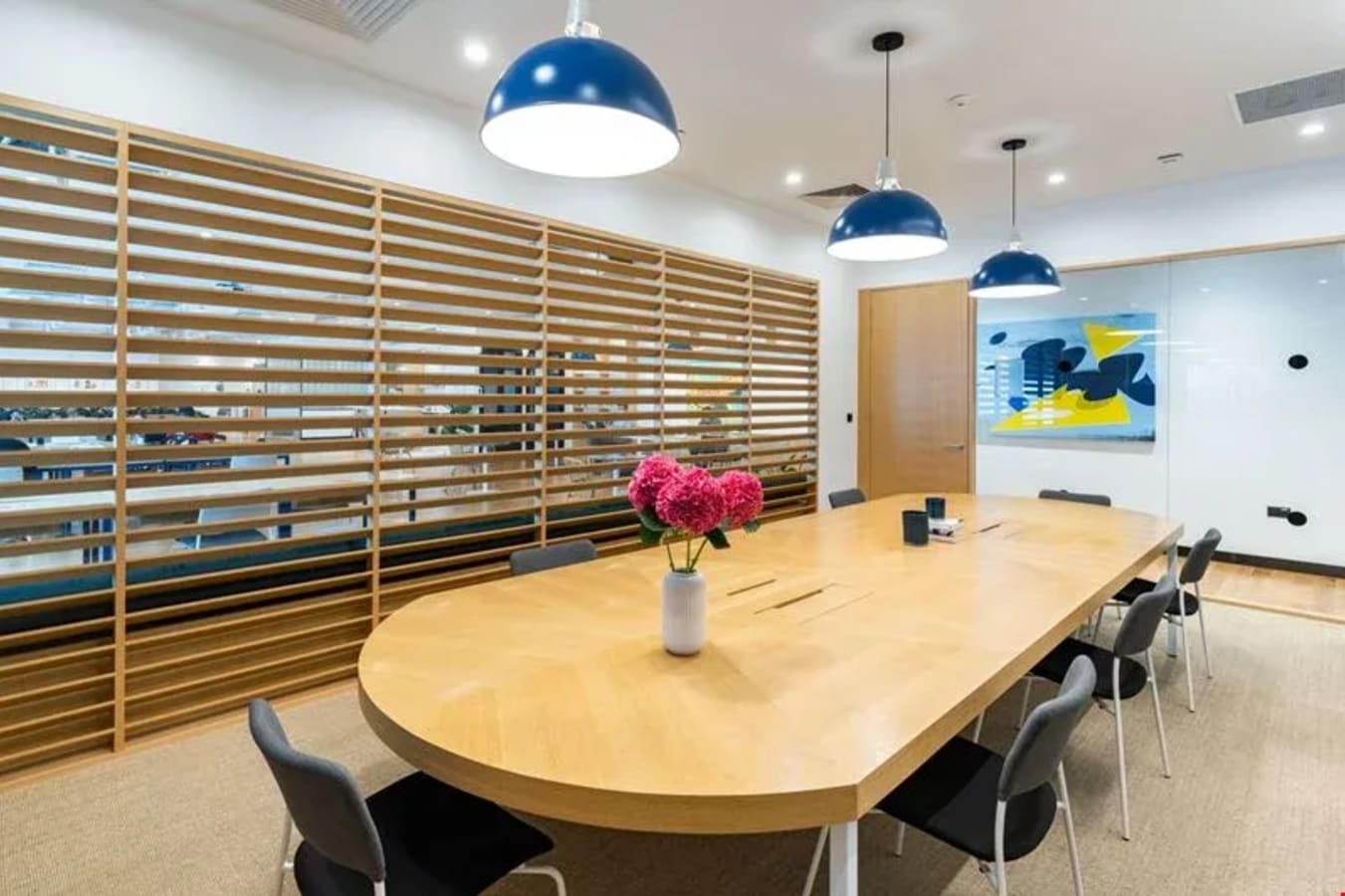 Contemporary coworking space with modern seating, artwork, and warm lighting in North Bridge Road.