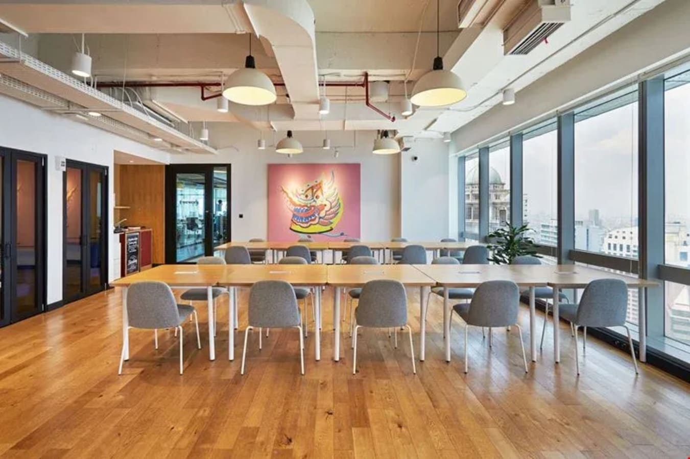 Modern coworking space with abundant natural light and a vibrant, artistic flair.