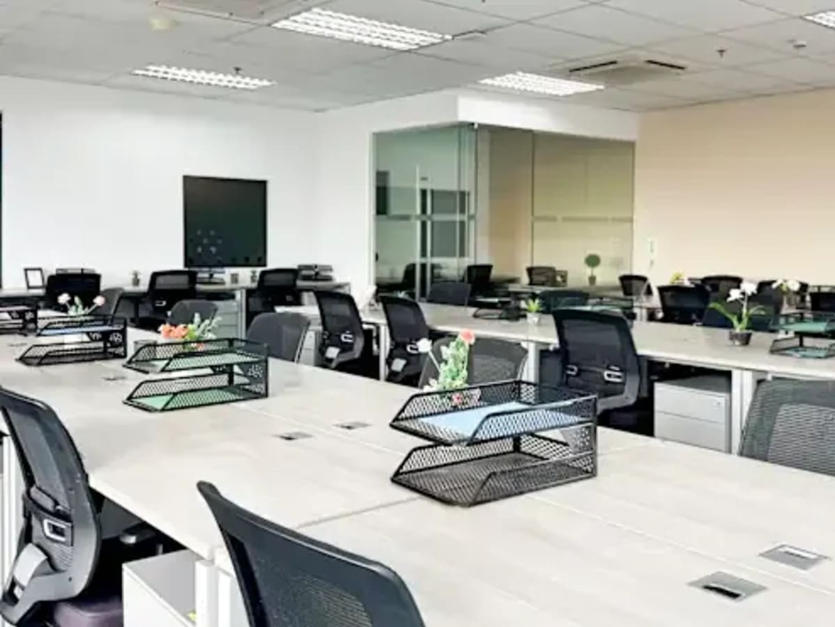 Modern coworking space in Fort Bonifacio with open desks, natural light, and sleek decor.