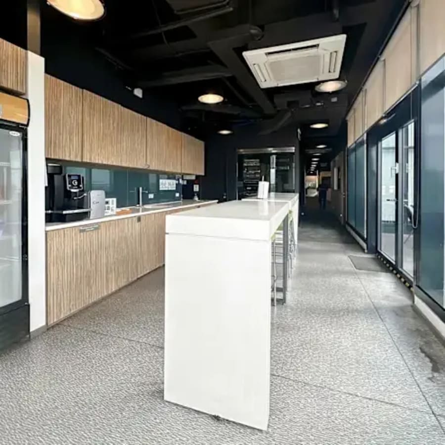 Modern coworking kitchen with sleek countertops and ample natural light in Fort Bonifacio.