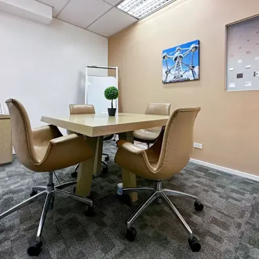 Modern meeting room with sleek chairs, vibrant decor, and a collaborative atmosphere.