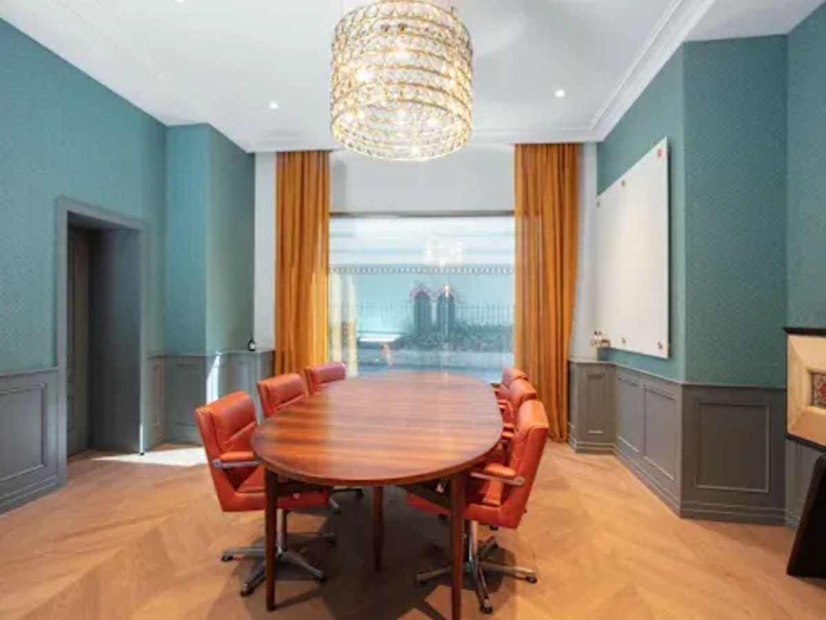Elegant meeting room in Taguig's flexible coworking space featuring a long table and stylish chairs.