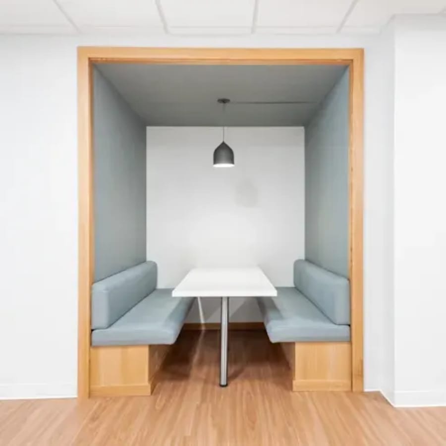 Cozy meeting nook with modern lighting and seating in Taguig coworking space. Ideal for collaboration.