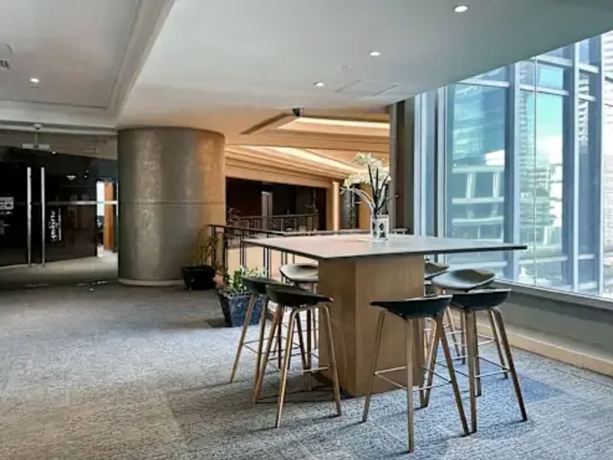 Modern coworking space in Makati with high stools, natural light, and a collaborative vibe.