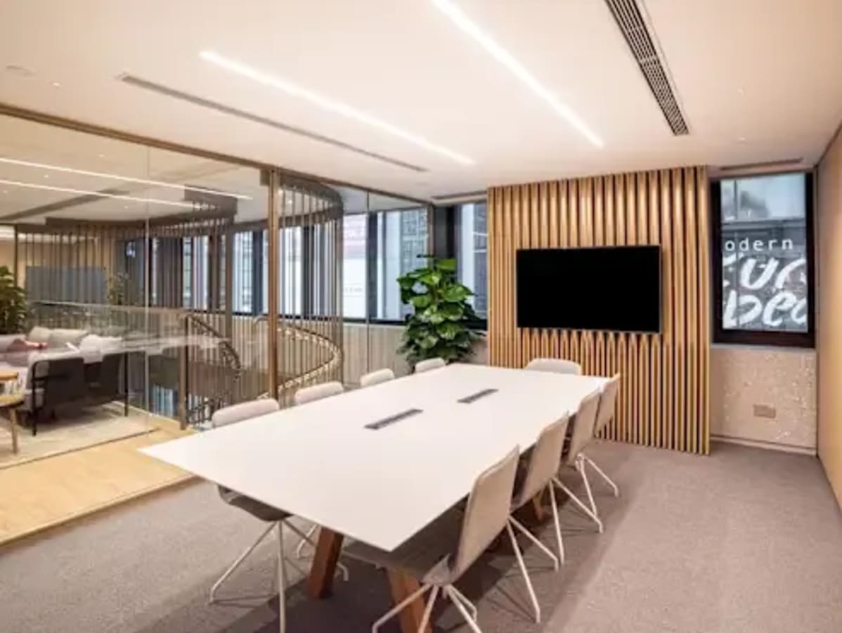 Modern coworking space in Makati with sleek meeting room, natural light, and minimalist design.