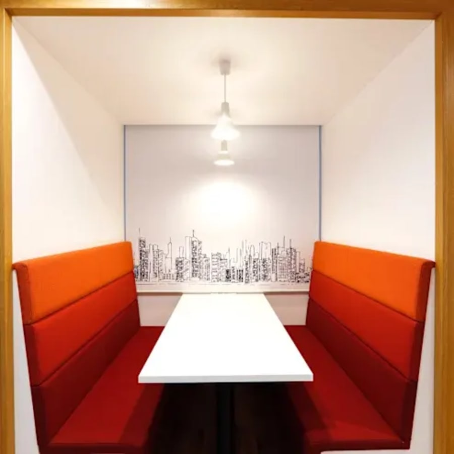 Cozy alcove with city skyline backdrop, perfect for focused work or meetings.