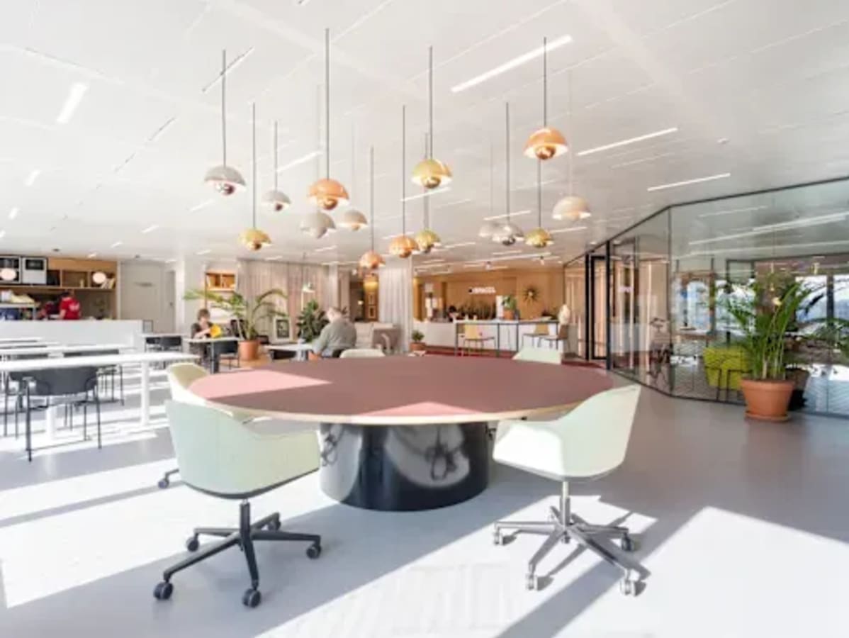 Bright and modern coworking space with versatile seating and abundant natural light.