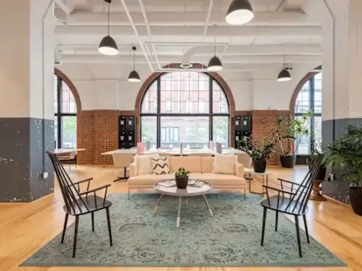 Bright coworking space with modern seating, large windows, and natural light in Taguig.