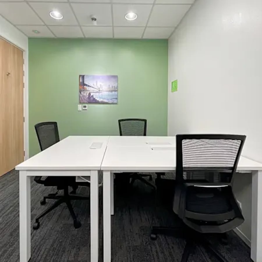 Modern coworking space with ergonomic chairs, large desks, and vibrant decor in Metro Manila.