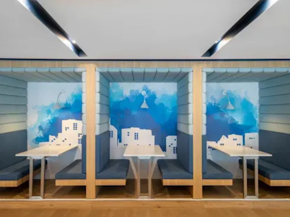 Cozy booth seating in a vibrant coworking space, perfect for collaboration and focus.