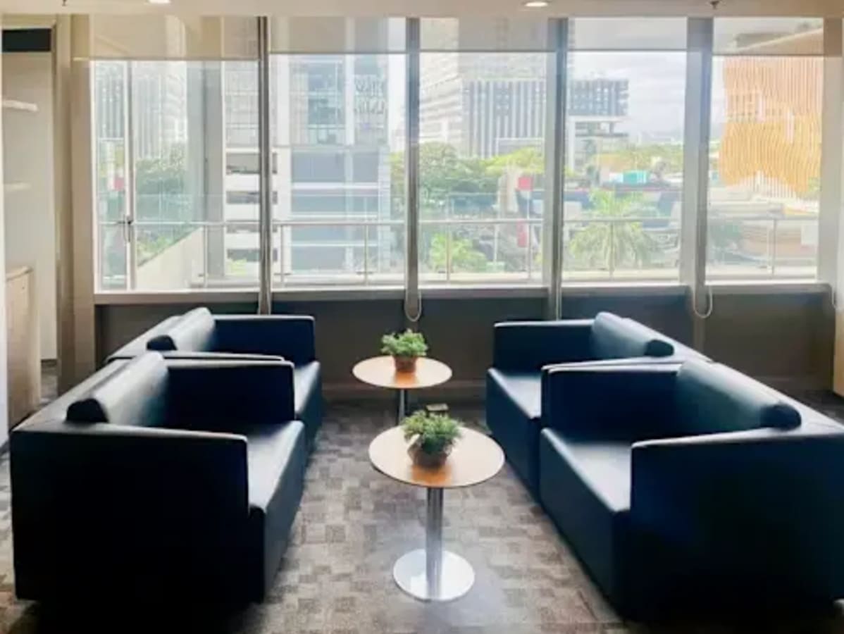 Bright Cebu coworking space with modern seating, natural light, and urban views. Ideal for collaboration.