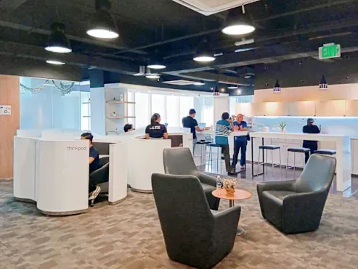 Modern coworking space in Cebu featuring open seating, private pods, and a welcoming lounge.