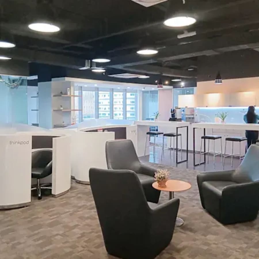 Modern coworking space in Cebu with sleek seating, natural light, and a well-equipped kitchenette.