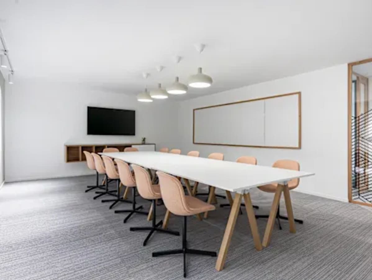 Modern meeting room with sleek table, ergonomic chairs, and ample lighting in Quezon City coworking space.
