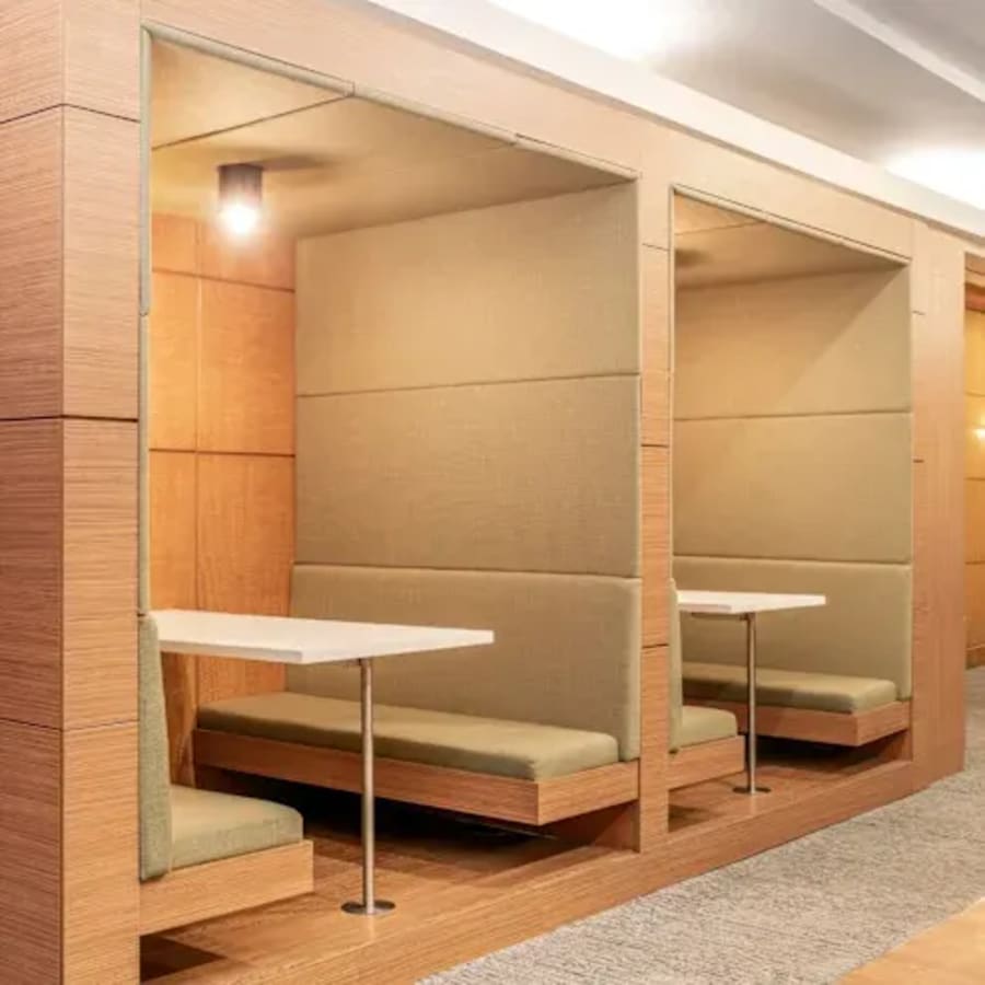 Modern coworking booths with cozy seating and soft lighting in Quezon City.