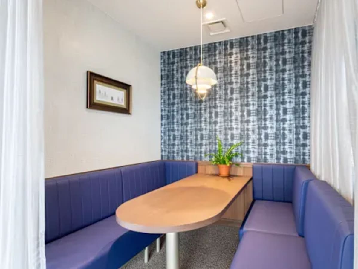 Cozy meeting nook with stylish booth seating and modern decor in Quezon City coworking space.