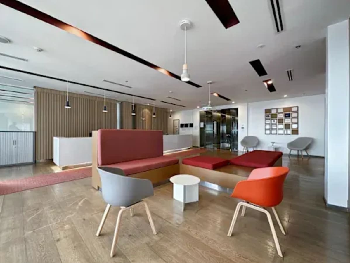 Modern coworking space with stylish seating and ample natural light on Ayala Avenue.