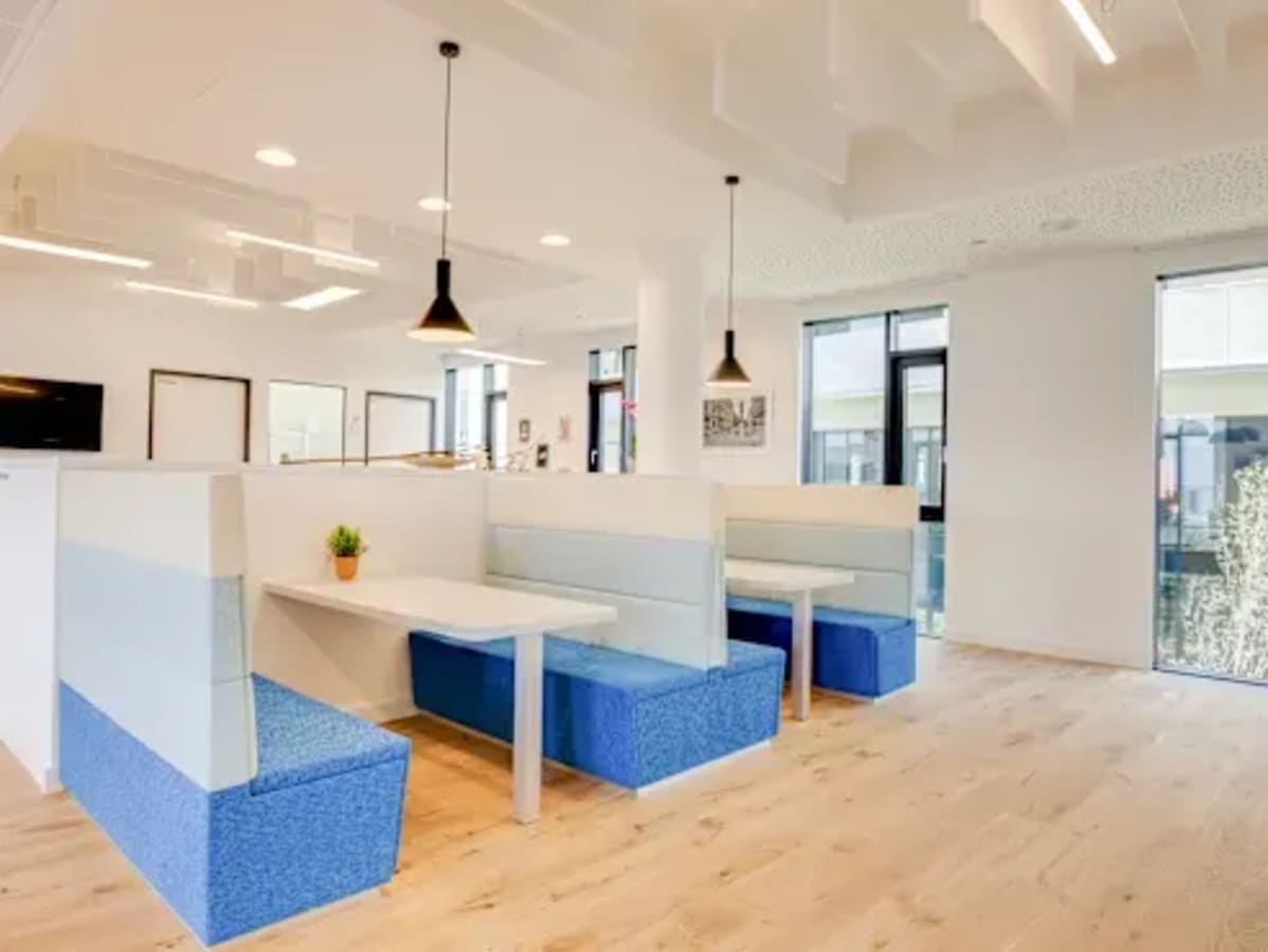Modern coworking space in Vadodara. Bright lighting, stylish booths, and an open layout for collaboration.