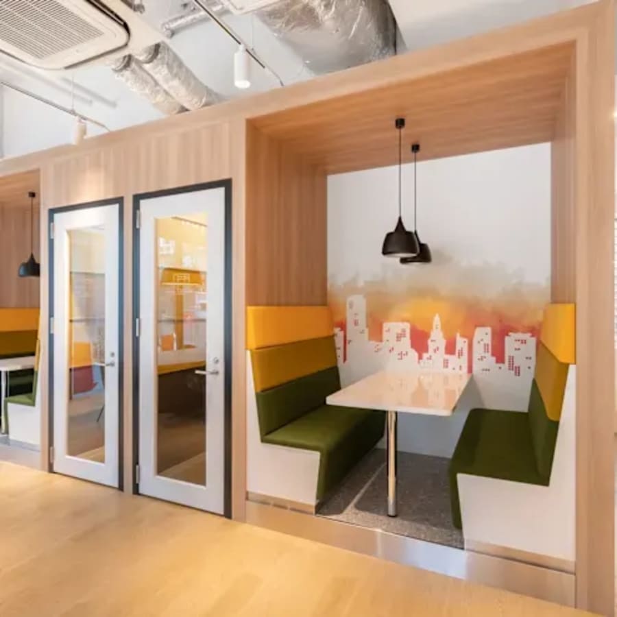 Modern coworking space with private booths and city-themed decor on White Field Road, Telangana.