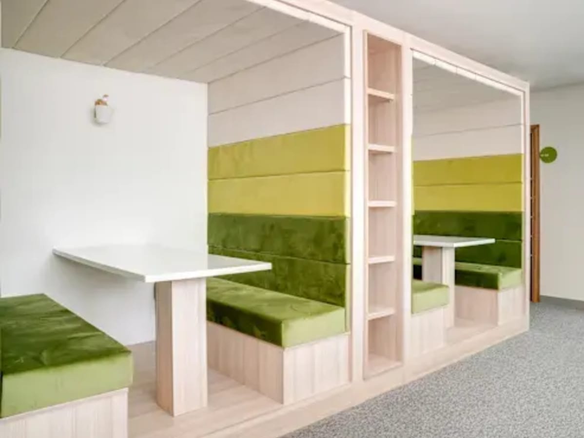 Modern coworking booths with plush seating, ideal for focused work and collaboration.