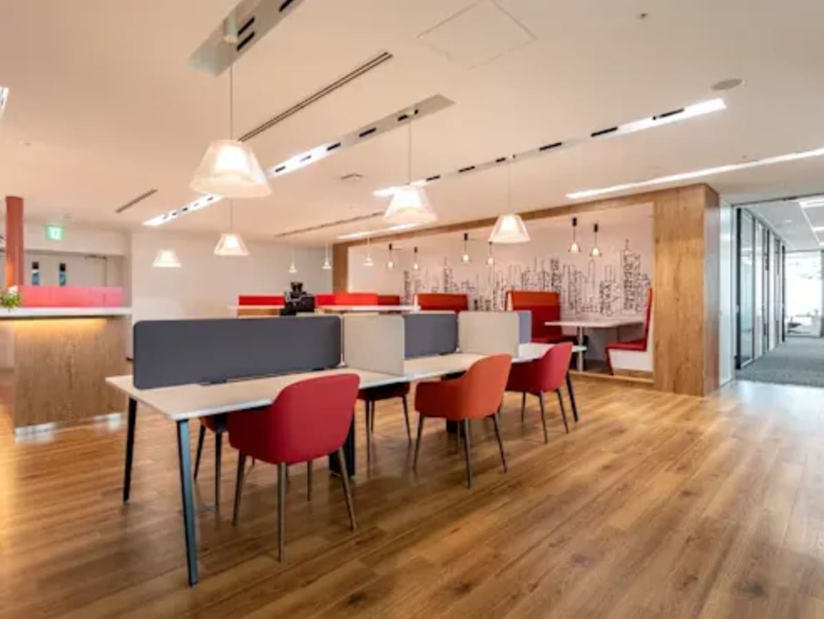Modern coworking space with vibrant seating, open layout, and ample natural light.