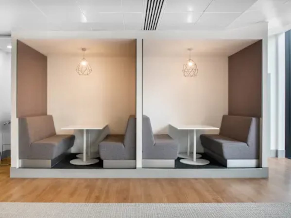 Modern coworking booths with stylish lighting, perfect for focused work in Hyderabad.