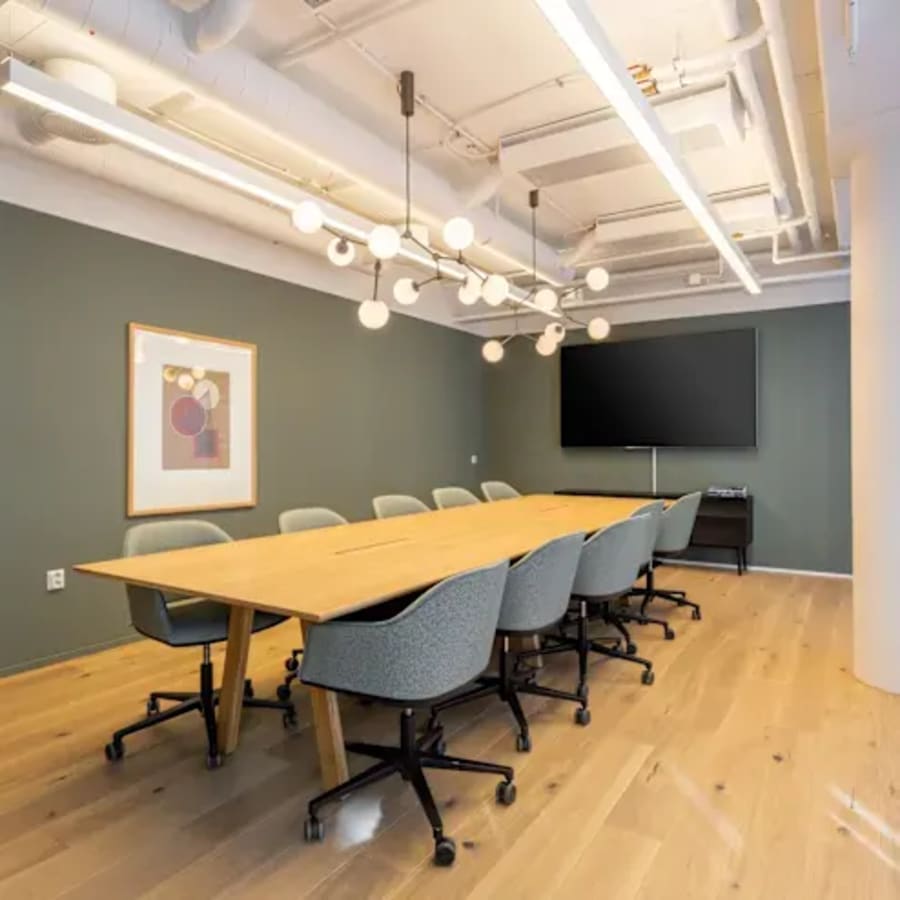 Modern conference room with sleek seating, ample lighting, and advanced AV setup.