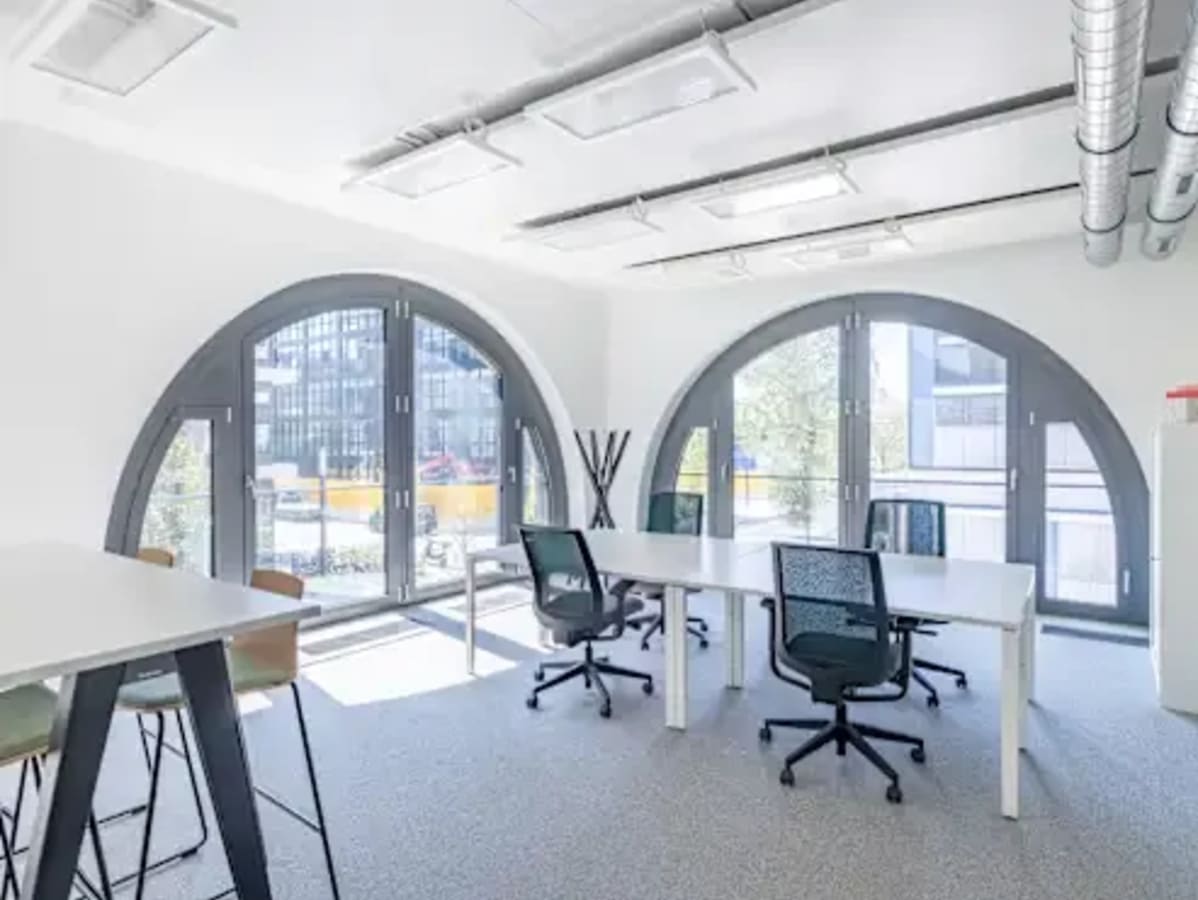 Bright coworking space in Hyderabad with modern furniture and ample natural light. Ideal for collaboration.