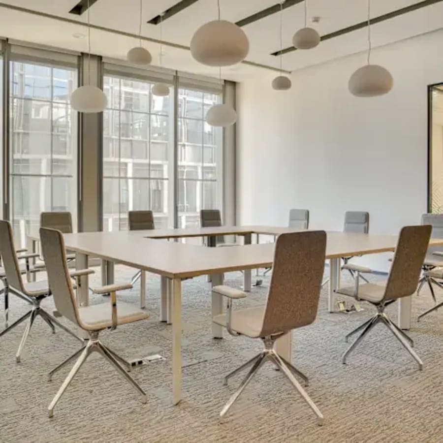 Modern coworking space with ample natural light and sleek furnishings in Hyderabad.