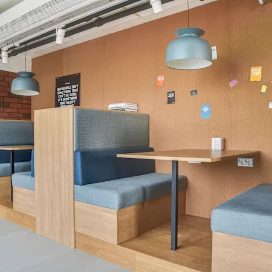 Modern coworking booths with cushioned seating and warm lighting in Hyderabad.