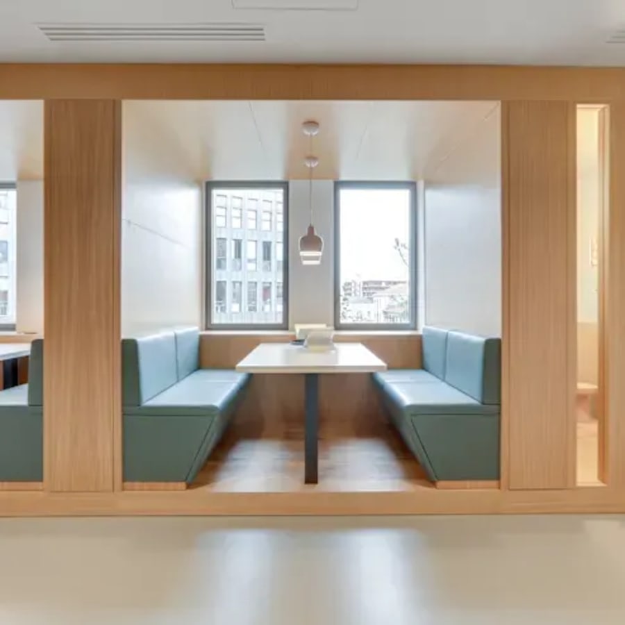 Stylish booth seating with natural light, perfect for collaborative work or meetings.