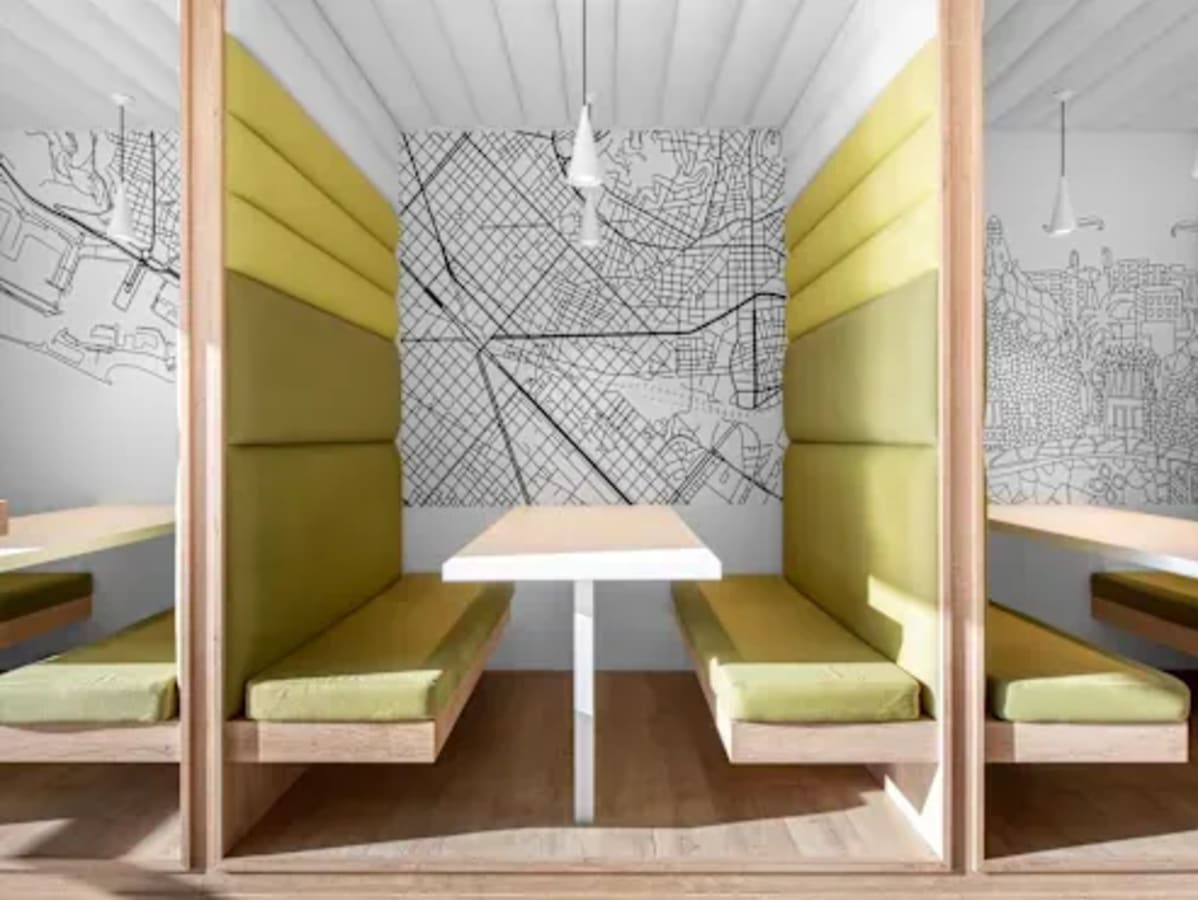 Modern coworking booths with stylish map-themed decor on Outer Ring Road, Karnataka.