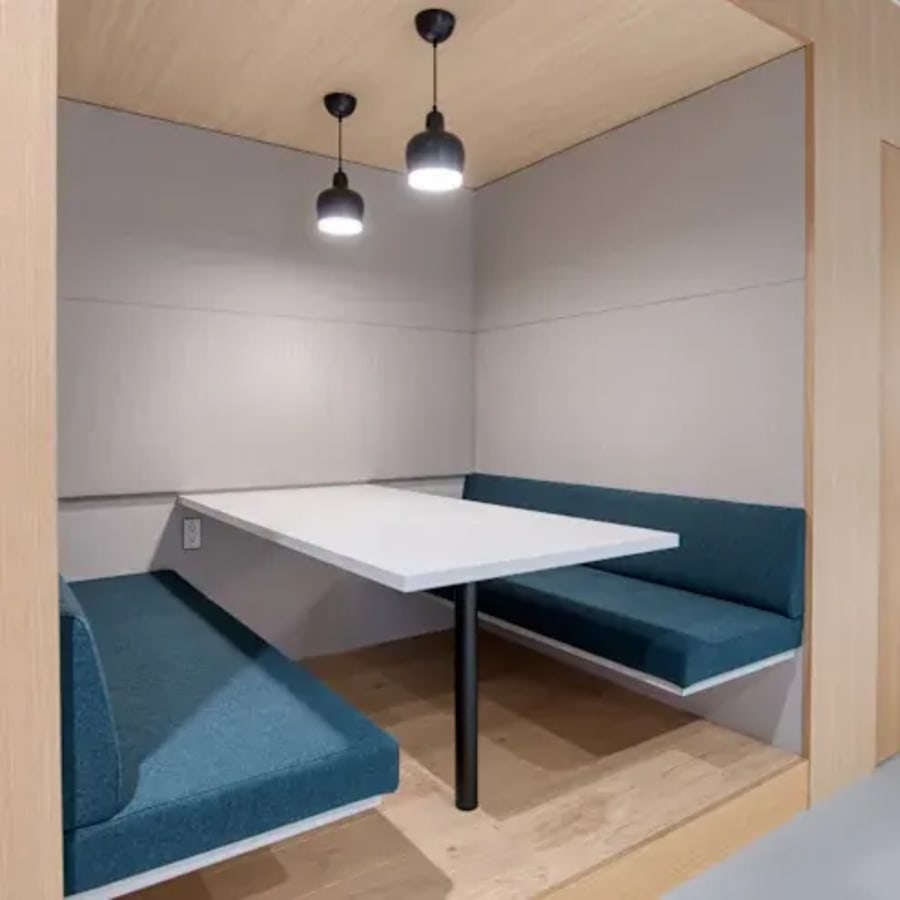 Cozy booth seating with modern lighting in a flexible coworking space on Outer Ring Road, Karnataka.