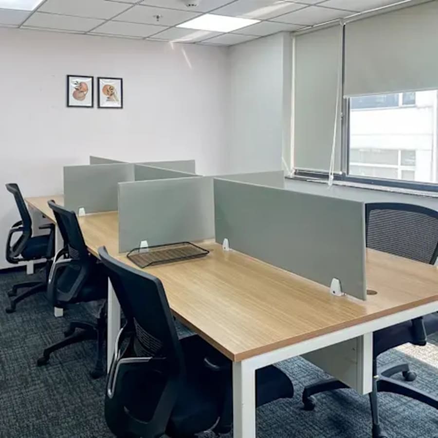 Bright, modern coworking space with ergonomic chairs and ample natural light on Sahastradhara Road.