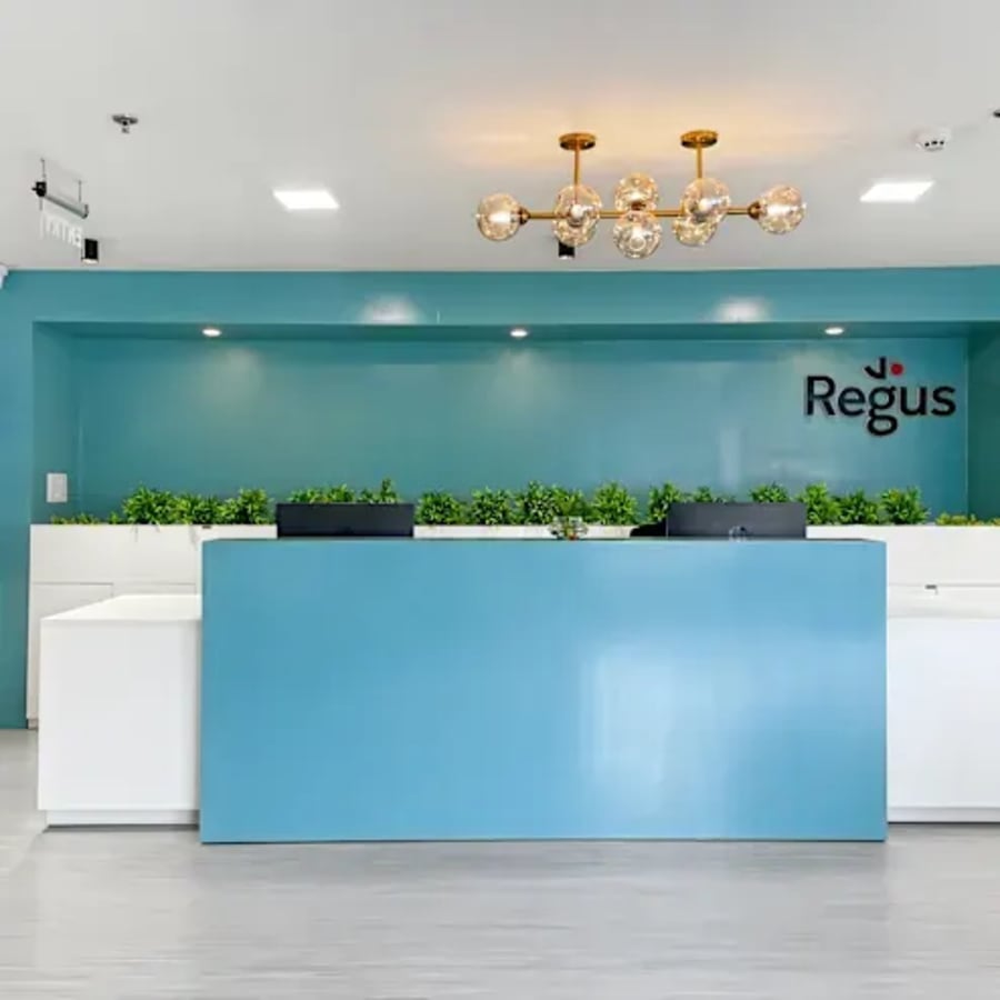 Modern reception area with sleek blue accents and ambient lighting, ideal for welcoming clients.