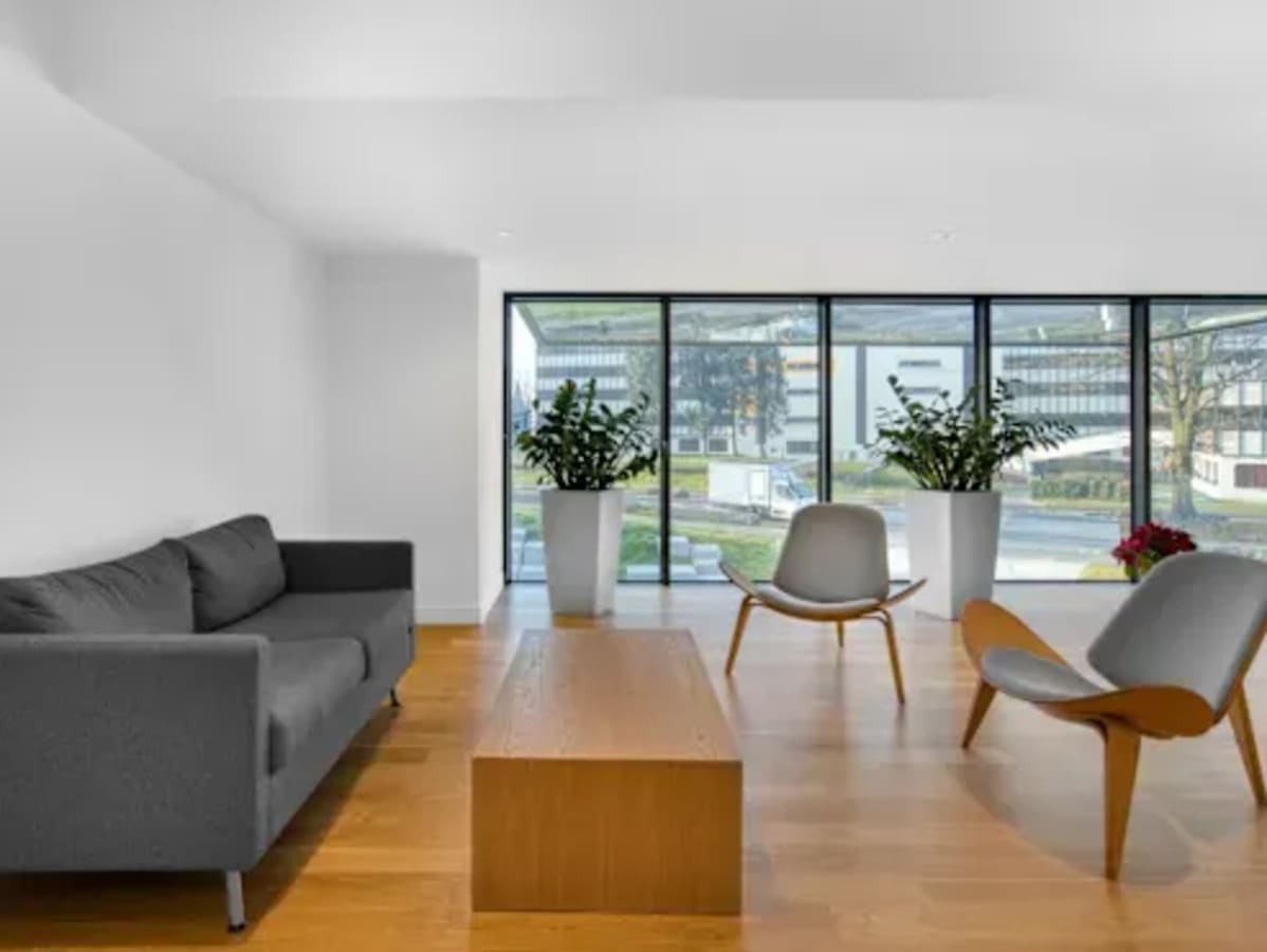 Modern lounge area with natural light, stylish seating, and scenic window views. Perfect for collaboration.