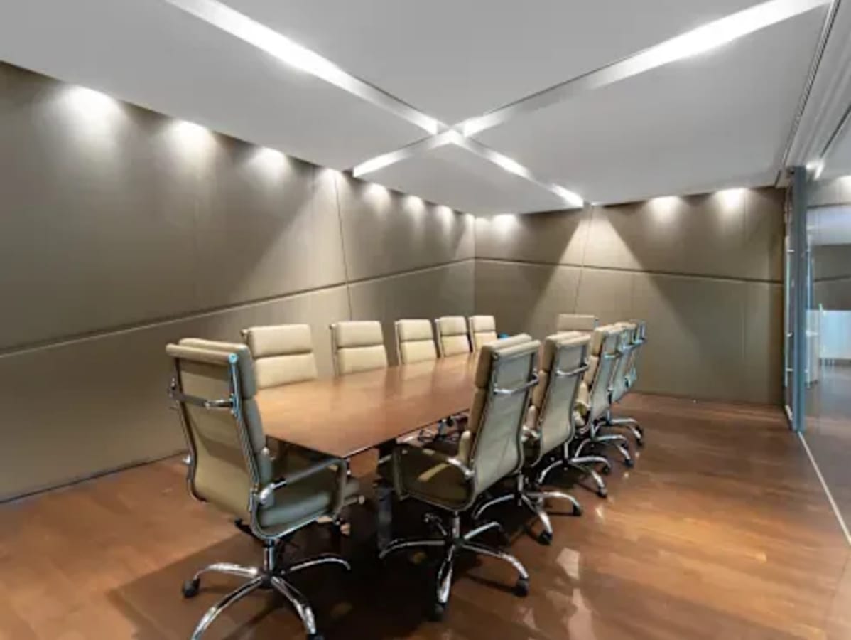 Sleek conference room with modern seating and elegant lighting. Ideal for collaborative meetings.