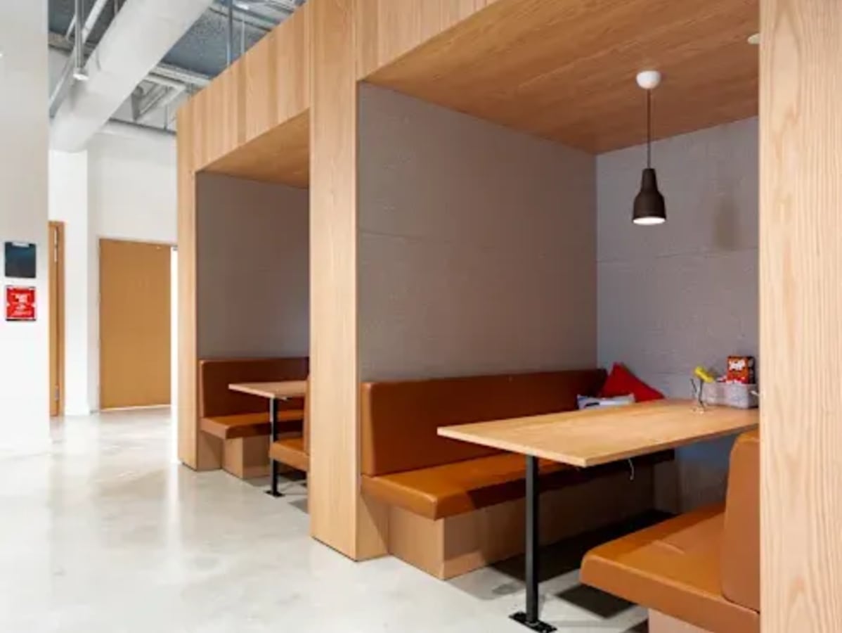 Cozy booth seating in a modern coworking space on Ambli-Bopal Road. Ideal for meetings or solo work.