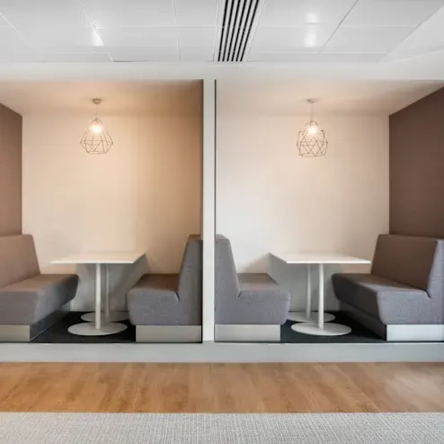 Modern coworking pods with chic lighting and comfortable seating on Ambli-Bopal Road.