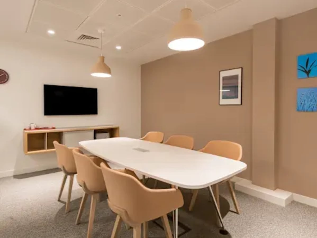 Modern meeting room in Kondapur coworking space with cozy seating and ample lighting.