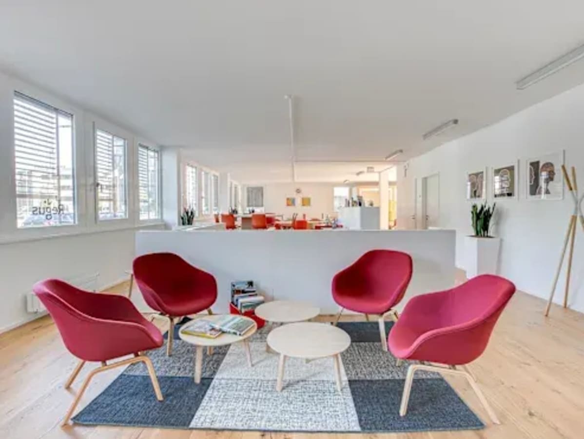 Bright coworking area with modern seating, natural light, and stylish decor. Perfect for collaboration.