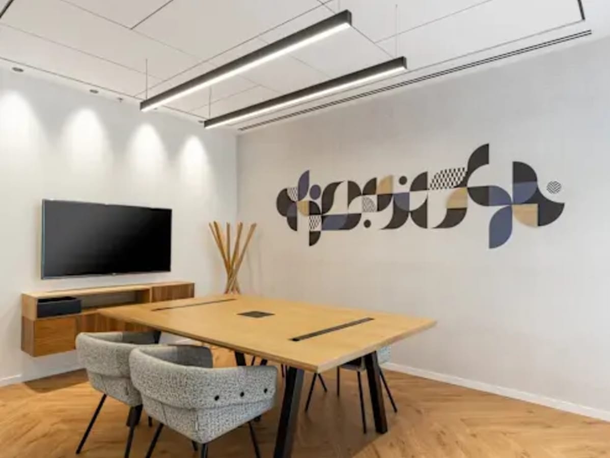 Modern meeting room with sleek décor, ample lighting, and comfortable seating in Narmada Road coworking space.