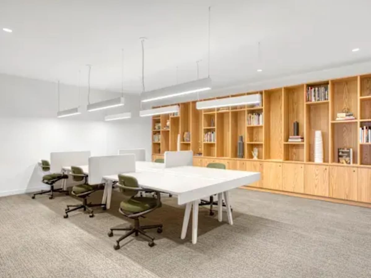 Modern coworking space with sleek desks, ergonomic chairs, and ample lighting on Narmada Road.